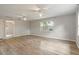Bright, open-concept living room boasts wood floors, neutral paint, and multiple ceiling fans at 408 Eunice Dr, Plant City, FL 33563