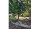 Backyard with mature trees, shrubs, rock border, and foliage at 820 Bayou Ave, Tarpon Springs, FL 34689