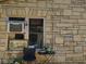 Exterior wall of home showing tan and brown bricks and a window with an AC unit at 820 Bayou Ave, Tarpon Springs, FL 34689
