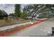 A view of the street and neighboring houses with mature trees and a paved sidewalk at 820 Bayou Ave, Tarpon Springs, FL 34689
