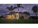 Charming single-story home featuring stucco exterior, arched windows, and a well-maintained lawn at 2668 Jablo Cir, North Port, FL 34288