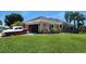 Well-maintained single-story home featuring arched windows, side entry garage and a lush green lawn at 2668 Jablo Cir, North Port, FL 34288