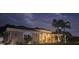 Lovely single-story home featuring a red front door, manicured landscaping, and side-entry garage at 2668 Jablo Cir, North Port, FL 34288