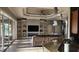 Living room with open built-ins, a modern ceiling fan, and sliding glass doors to the pool at 2668 Jablo Cir, North Port, FL 34288