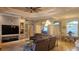 Open-concept living room and dining room with tray ceilings at 2668 Jablo Cir, North Port, FL 34288