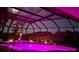 A dazzling screened pool area with pink lighting at night at 2668 Jablo Cir, North Port, FL 34288