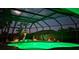 Stunning screened pool with vibrant green lighting, perfect for nighttime relaxation at 2668 Jablo Cir, North Port, FL 34288