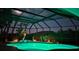 An exquisite screened pool area with green lighting at night at 2668 Jablo Cir, North Port, FL 34288