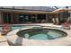Beautiful backyard pool area with a jacuzzi, patio furniture, and colorful potted plants at 2668 Jablo Cir, North Port, FL 34288