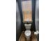 Small water closet featuring toilet with faux flower on top of the tank at 2668 Jablo Cir, North Port, FL 34288
