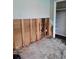 Bathroom demolition in progress with exposed plumbing and studs, showing potential for renovation at 7240 Donna Dr, New Port Richey, FL 34652