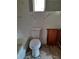 Bathroom featuring a toilet, bathtub, and small window, with evidence of demolition and repair work at 7240 Donna Dr, New Port Richey, FL 34652