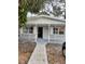 Charming single-story home featuring a welcoming front porch with decorative ironwork and an open entryway at 7240 Donna Dr, New Port Richey, FL 34652