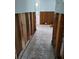 Hallway renovation, showing the tile floor and exposed wall studs, leading to a doorway and back room at 7240 Donna Dr, New Port Richey, FL 34652