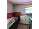 Kitchen featuring a sink with granite countertop, stainless steel freezer, and natural light from a window at 7240 Donna Dr, New Port Richey, FL 34652
