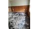 Renovation progress in a room with exposed wall studs, wood paneling, and debris-covered floors at 7240 Donna Dr, New Port Richey, FL 34652