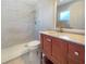 Contemporary bathroom featuring a walk-in shower with marble-like tile, and a modern vanity with a marble countertop at 18019 Avonsdale Cir, Port Charlotte, FL 33948