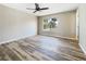 Bedroom with ceiling fan, hardwood floors, natural light and a view of palm trees at 18019 Avonsdale Cir, Port Charlotte, FL 33948