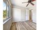 Bedroom with hardwood floors, closet, large window, and neutral paint at 18019 Avonsdale Cir, Port Charlotte, FL 33948
