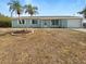 Charming single-story home with a well-maintained lawn and beautiful landscaping, including two palm trees at 18019 Avonsdale Cir, Port Charlotte, FL 33948