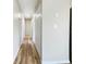 Hallway featuring contemporary flooring and updated lighting, showcasing a seamless transition between spaces at 18019 Avonsdale Cir, Port Charlotte, FL 33948