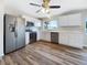 Modern kitchen featuring stainless steel appliances, white cabinets, and a bright window overlooking the backyard at 18019 Avonsdale Cir, Port Charlotte, FL 33948