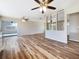 Open-concept living space featuring hardwood floors, bright lighting, and sliding glass doors at 18019 Avonsdale Cir, Port Charlotte, FL 33948