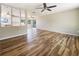 Spacious living room features hardwood floors, a ceiling fan, and abundant natural light at 18019 Avonsdale Cir, Port Charlotte, FL 33948