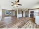 Open floor plan with hardwood floors connecting living room to kitchen with stainless steel appliances at 18019 Avonsdale Cir, Port Charlotte, FL 33948