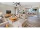 Bright, open-concept living area flowing into the dining and kitchen spaces with modern finishes and ample natural light at 18019 Avonsdale Cir, Port Charlotte, FL 33948