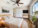 Cozy main bedroom with hardwood floors, a ceiling fan, and a large window for plenty of natural light at 18019 Avonsdale Cir, Port Charlotte, FL 33948