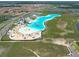 An aerial view of community with resort-style amenities and a lagoon at 5144 Flowing Oar Rd, Wimauma, FL 33598