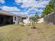 Spacious backyard with well-maintained grass, privacy fence, and patio area at 5144 Flowing Oar Rd, Wimauma, FL 33598
