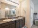 Bathroom features double sinks, granite counters, and a glass-enclosed shower at 5144 Flowing Oar Rd, Wimauma, FL 33598