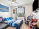 Cozy bedroom with Boston sports decor, a ceiling fan, and comfortable furnishings at 5144 Flowing Oar Rd, Wimauma, FL 33598