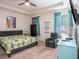 Relaxing bedroom with a plush bed, colorful artwork, and natural light, creating a serene atmosphere at 5144 Flowing Oar Rd, Wimauma, FL 33598