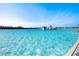Expansive, bright blue swimming pool with water features and water slides in a planned community at 5144 Flowing Oar Rd, Wimauma, FL 33598