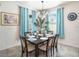 Cozy dining room with elegant light fixture and curtains, providing a comfortable space for meals at 5144 Flowing Oar Rd, Wimauma, FL 33598