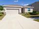 Charming single-story home with a two-car garage and a well-manicured lawn, perfect for families at 5144 Flowing Oar Rd, Wimauma, FL 33598