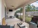 Enclosed lanai features a TV and provides access to a well-maintained backyard at 5144 Flowing Oar Rd, Wimauma, FL 33598