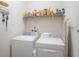 Laundry room featuring a washer and dryer with shelving for storage at 5144 Flowing Oar Rd, Wimauma, FL 33598