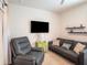 Comfortable living room includes a leather recliner, a gray sofa and a ceiling fan at 5144 Flowing Oar Rd, Wimauma, FL 33598