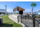 Outdoor entertainment area with a raised stage, a large screen television, and green space for seating at 5144 Flowing Oar Rd, Wimauma, FL 33598