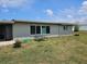 Spacious backyard area with a picnic table and a fire pit, perfect for outdoor gatherings at 119 Caddy Rd, Rotonda West, FL 33947