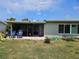 Backyard showcasing a covered patio, picnic table and fire pit for outdoor living at 119 Caddy Rd, Rotonda West, FL 33947