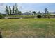Lush backyard view featuring a canal and manicured lawn, with some outdoor furniture at 119 Caddy Rd, Rotonda West, FL 33947