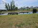 Backyard view featuring a canal and lush greenery, offering a serene outdoor setting at 119 Caddy Rd, Rotonda West, FL 33947
