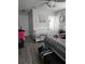 This bedroom offers a crib, gray wood floors, a ceiling fan, and decor at 119 Caddy Rd, Rotonda West, FL 33947