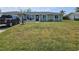 Charming single-story home featuring a well-maintained lawn and inviting front porch at 119 Caddy Rd, Rotonda West, FL 33947