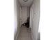 Hallway with neutral walls and ceramic tile flooring at 119 Caddy Rd, Rotonda West, FL 33947